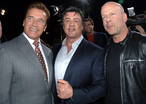 Sylvester Stallone and Arnold Schwarzenneger posing.
